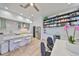Modern kitchen features an island with marble countertop and white cabinets, plus a built-in shelving with cabinets at 3012 W Barcelona St # 7, Tampa, FL 33629
