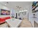 Open-concept kitchen and dining area featuring modern white cabinetry, stainless steel appliances, and stylish decor at 3012 W Barcelona St # 7, Tampa, FL 33629