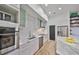 Modern kitchen featuring white cabinetry, stainless steel appliances, and a subway tile backsplash with bright lighting at 3012 W Barcelona St # 7, Tampa, FL 33629