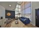 Stylish living room with a blue sofa, unique decor, and large windows, complemented by hardwood floors at 3012 W Barcelona St # 7, Tampa, FL 33629