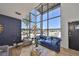 Spacious living room with two story windows, modern decor, and ample natural light at 3012 W Barcelona St # 7, Tampa, FL 33629