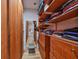 Organized walk-in closet with wooden shelves and drawers, offering plenty of storage at 3012 W Barcelona St # 7, Tampa, FL 33629