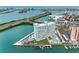 Aerial view of high rise waterfront condo building with pool and boat docks at 31 Island Way # 1507, Clearwater Beach, FL 33767