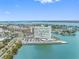 Expansive aerial view of the building complex on the water, with city views and nearby residential areas in the background at 31 Island Way # 1507, Clearwater Beach, FL 33767