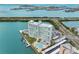 Aerial view of a waterfront condo with parking, pool, boat slips, and beautiful water views at 31 Island Way # 1507, Clearwater Beach, FL 33767