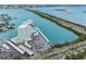 Aerial view of waterfront condo building with pool and boat docks on clear blue water at 31 Island Way # 1507, Clearwater Beach, FL 33767