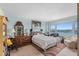 Comfortable bedroom with a large window showcasing a scenic view of the bay and nearby city at 31 Island Way # 1507, Clearwater Beach, FL 33767