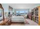 Bedroom with large windows offering beautiful water views, complete with wooden furnishings at 31 Island Way # 1507, Clearwater Beach, FL 33767