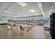 Well-lit community room with multiple tables, chairs, and large windows providing panoramic views at 31 Island Way # 1507, Clearwater Beach, FL 33767