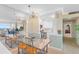 Open concept dining area with chandelier and views into the kitchen and the city skyline at 31 Island Way # 1507, Clearwater Beach, FL 33767