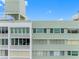 View of condo building exterior with various windows and balconies against a bright sky at 31 Island Way # 1507, Clearwater Beach, FL 33767