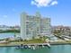 Exterior view of a waterfront high-rise condo building featuring boat slips and swimming pool at 31 Island Way # 1507, Clearwater Beach, FL 33767