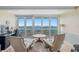 Cozy sitting area with chairs and a small table in front of floor to ceiling windows at 31 Island Way # 1507, Clearwater Beach, FL 33767