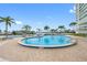 Outdoor swimming pool with a view of the water and palm trees at 31 Island Way # 1507, Clearwater Beach, FL 33767
