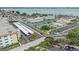 Aerial view showcasing community amenities like tennis court, parking, and nearby roadways at 3128 59Th S St # 206, Gulfport, FL 33707