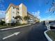 Low-rise condo building with a clean facade, well-kept landscaping, and ample parking at 3128 59Th S St # 206, Gulfport, FL 33707