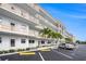 Exterior view of the condo building with balconies, palm trees, and ample parking at 3128 59Th S St # 206, Gulfport, FL 33707