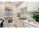 Compact kitchen with stainless steel sink, white cabinetry and window view to the living area at 3128 59Th S St # 206, Gulfport, FL 33707