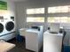 Bright laundry room featuring two washers, dryers, and sink with a view at 3128 59Th S St # 206, Gulfport, FL 33707