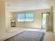 Bright, carpeted living room featuring a large window with blind and a decorative area rug at 3128 59Th S St # 206, Gulfport, FL 33707
