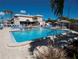 Expansive swimming pool with clear blue water, surrounded by lounge chairs and lush landscaping at 3128 59Th S St # 206, Gulfport, FL 33707