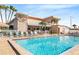 Beautiful community pool area with ample seating, landscaping, and building views for relaxation and enjoyment at 3128 59Th S St # 206, Gulfport, FL 33707