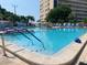 Large community pool with stairs, handrails, and building views, ideal for recreation and relaxation at 3128 59Th S St # 206, Gulfport, FL 33707