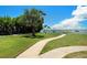 Beautiful waterfront park with a path, mature trees, benches, and scenic views of the water at 3128 59Th S St # 206, Gulfport, FL 33707