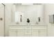 The modern bathroom includes a dual sink vanity with a marble countertop and a large mirror at 31781 Griffin Sands Ln, San Antonio, FL 33576