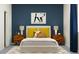 Stylish bedroom with blue accent wall, mid-century modern nightstands, and a king-size bed at 31781 Griffin Sands Ln, San Antonio, FL 33576