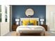 This bedroom features a comfortable king-size bed with yellow and blue pillows at 31781 Griffin Sands Ln, San Antonio, FL 33576
