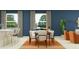 Modern dining area with seating for six, large windows, and an open floor plan at 31781 Griffin Sands Ln, San Antonio, FL 33576