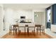 Bright and airy kitchen adjacent to dining area, featuring white cabinetry and stainless steel appliances at 31781 Griffin Sands Ln, San Antonio, FL 33576