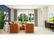This living room is filled with natural light, neutral tones, and modern, stylish decor at 31781 Griffin Sands Ln, San Antonio, FL 33576