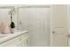 Modern bathroom featuring double vanity, quartz countertop, and glass-enclosed shower with tile at 32078 Griffin Sands Ln, San Antonio, FL 33576