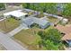 Aerial view of home with a pool, nice landscaping, and a two-car garage at 3353 Montano Ave, Spring Hill, FL 34609