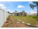 Fenced backyard showcasing stone pathway and landscaped areas at 3353 Montano Ave, Spring Hill, FL 34609