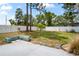 Grassy fenced backyard with a patio space and block wall planter at 3353 Montano Ave, Spring Hill, FL 34609