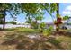 Spacious backyard featuring an orange tree and custom stone firepit at 3353 Montano Ave, Spring Hill, FL 34609