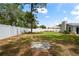 Large, fenced backyard featuring a custom stone firepit at 3353 Montano Ave, Spring Hill, FL 34609