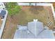 Aerial view of backyard, showcasing landscaping, a fire pit, and a white vinyl fence at 3353 Montano Ave, Spring Hill, FL 34609