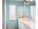 Bright bathroom with a modern vanity, mirror and updated fixtures at 3353 Montano Ave, Spring Hill, FL 34609