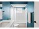 Bathroom with blue walls, vanity and shower with white tile at 3353 Montano Ave, Spring Hill, FL 34609