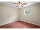 Modest bedroom with a window, ceiling fan and wood-look floors at 3353 Montano Ave, Spring Hill, FL 34609