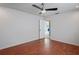 A spacious bedroom featuring a ceiling fan and wood-look floors at 3353 Montano Ave, Spring Hill, FL 34609