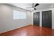 Neutral bedroom with a ceiling fan, wood-look floors, and two closets at 3353 Montano Ave, Spring Hill, FL 34609