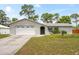 Charming single-story home featuring an attached two-car garage and well-maintained front lawn at 3353 Montano Ave, Spring Hill, FL 34609