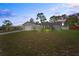 Scenic single-story home at dusk featuring an attached garage, a driveway, and a front lawn at 3353 Montano Ave, Spring Hill, FL 34609