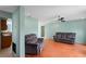 Spacious living room with wood floors, ample seating, ceiling fan, and fresh paint at 3353 Montano Ave, Spring Hill, FL 34609