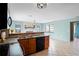 Bright living area features a stone fireplace, tile flooring, and a seamless flow to the kitchen for easy living at 3353 Montano Ave, Spring Hill, FL 34609